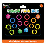 Sensory Sprouts Textured Fidget Rings packaging displaying twelve colourful silicone rings in various textures including ridged, smooth, and spiked designs in pink, blue, orange, yellow, and green. Packaging features text "twist Me!", "SPIN Me!", "ROLL Me!", and "Stack Me!" with age recommendation 3+ and tagline "Mindful play with room to grow!"