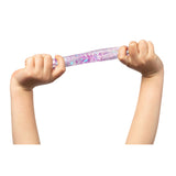 Two hands stretching a translucent purple sensory tube filled with iridescent pink, purple and blue glitter confetti. The flexible tactile toy demonstrates its stretchable properties as it extends between the child's hands, with sparkles suspended in clear gel creating a mesmerising visual effect ideal for sensory play and calming activities.