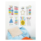 Eight colourful educational posters displayed on a white wall above a cosy reading nook with blue bean bag and textured cushions. The Growing Minds poster set features mindfulness themes including CALMING STRATEGIES, IT IS OKAY TO, STAR BREATHING, GROWTH MINDSET, TRIANGLE BREATHING, THE POWER OF YET, A LITTLE PROGRESS EACH DAY ADDS UP TO BIG RESULTS, and CHECK IN WITH YOURSELF with reflective prompts.