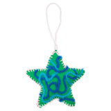 A hand-stitched felt star sample made using Zart Felt Star Decorations, in green with a looping turquoise and navy yarn design across the surface. White blanket stitching traces the star's outline, with the raised yarn creating a textured, decorative pattern over the plain felt base.