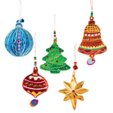 Five ornament shapes crafted from Zart Aluminium Embossing Foil, hand-painted in bold metallic colours and embellished with gems and beaded hangers: a blue striped bauble, a red teardrop bauble, a green Christmas tree with lights, a copper bell with stars, and a gold eight-pointed star.