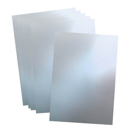 Several Aluminium Embossing Foil Sheets in silver are layered and slightly offset, showing a smooth, cool-toned metallic finish with soft reflections. The sheets appear thin and flexible, with clean edges and a subtle brushed texture across the surface.