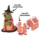 The painted terracotta witch figure beside two unpainted terracotta figures holding painted lollipop shapes on sticks, a painted red-and-white candy cane, and a terracotta gingerbread house with a white icing-effect roof. Annotations read "Use with Acrylic Paint" and "Use with Mixed Media".