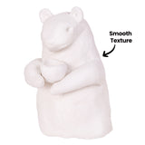 A single unpainted white clay bear figure holding a small cup shape, shown close up. The annotation "Smooth Texture" with an arrow points to the even, matte surface of the clay body.