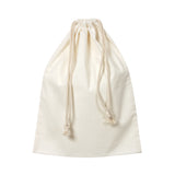 Plain natural calico cotton drawstring bag shown upright against a white background. The soft fabric has a slightly textured, matte surface with visible fibres. Cream cord ties gather the top, creating gentle folds and a relaxed, lightweight structure.