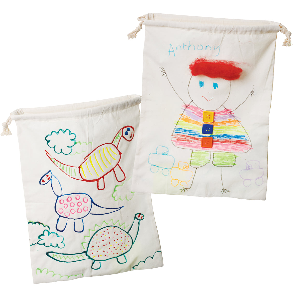 Two natural calico drawstring bags displayed with children’s drawings. One shows colourful dinosaurs outlined in bright marker, while the other features a figure labelled “Anthony” with a rainbow-striped outfit and buttons. The fabric appears soft, slightly wrinkled, and textured.