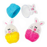 Clear plastic fillable Easter bunny containers in three vibrant colours: bright pink, sunny yellow, and turquoise blue. Each bunny features a cute white face with pink cheeks, whiskers, and bunny ears. The textured, egg-shaped bases separate from the transparent dome tops for easy filling with treats or small craft supplies.