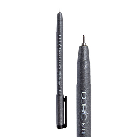 A Copic Multi Liner fineliner pen with a 0.3mm nib, shown uncapped alongside a close-up of the tip. The dark grey speckled barrel displays white "COPIC MULTI LINER" lettering and a black clip on the cap. The metal-collared nib extends to a fine black point.