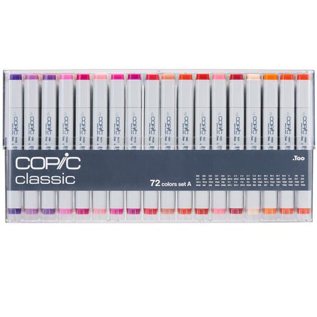 A clear plastic case holding Copic Classic markers arranged in two horizontal rows. The markers have white barrels with grey ends and coloured caps in shades of purple, pink, red, orange, and peach.