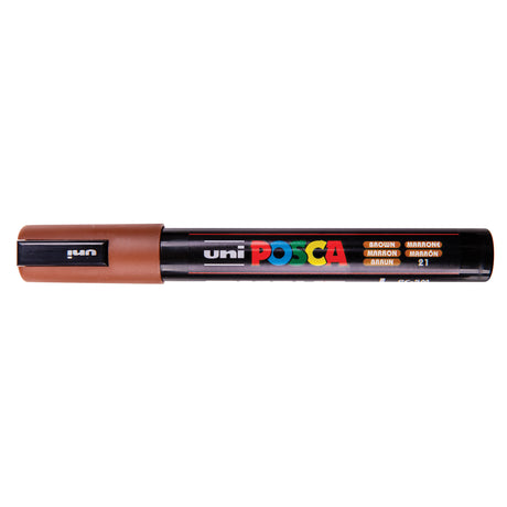 A uni POSCA paint marker shown horizontally against a white background. The glossy black cylindrical barrel carries the colourful POSCA branding and is topped by a uni clip, with the coloured cap or exposed bullet nib indicating the paint colour inside.