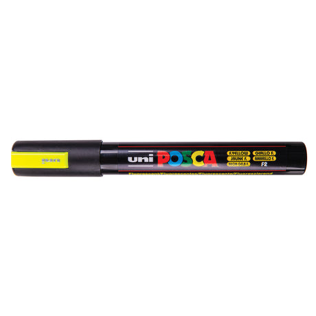 A uni POSCA paint marker shown horizontally against a white background. The glossy black cylindrical barrel carries the colourful POSCA branding and is topped by a uni clip, with the coloured cap or exposed bullet nib indicating the paint colour inside.