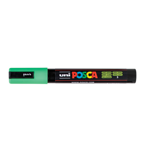 A uni POSCA paint marker shown horizontally against a white background. The glossy black cylindrical barrel carries the colourful POSCA branding and is topped by a uni clip, with the coloured cap or exposed bullet nib indicating the paint colour inside.