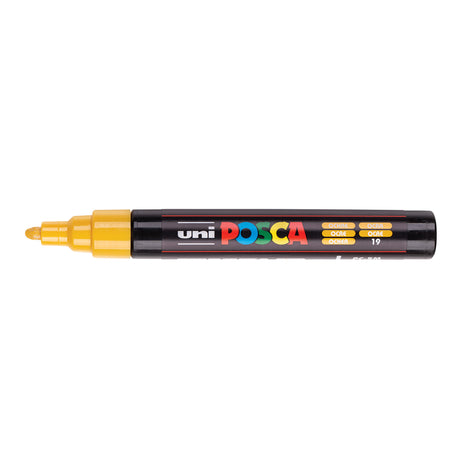 A uni POSCA paint marker shown horizontally against a white background. The glossy black cylindrical barrel carries the colourful POSCA branding and is topped by a uni clip, with the coloured cap or exposed bullet nib indicating the paint colour inside.