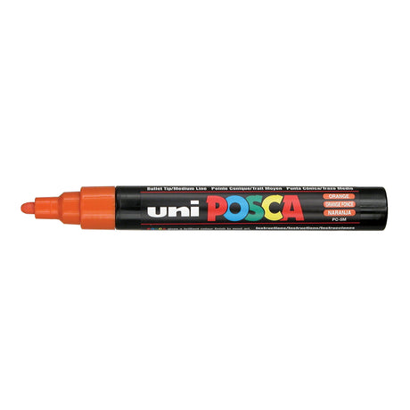 A uni POSCA paint marker shown horizontally against a white background. The glossy black cylindrical barrel carries the colourful POSCA branding and is topped by a uni clip, with the coloured cap or exposed bullet nib indicating the paint colour inside.