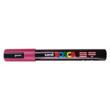 A uni POSCA paint marker shown horizontally against a white background. The glossy black cylindrical barrel carries the colourful POSCA branding and is topped by a uni clip, with the coloured cap or exposed bullet nib indicating the paint colour inside.