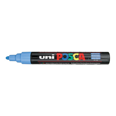 A uni POSCA paint marker shown horizontally against a white background. The glossy black cylindrical barrel carries the colourful POSCA branding and is topped by a uni clip, with the coloured cap or exposed bullet nib indicating the paint colour inside.