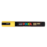 A uni POSCA paint marker shown horizontally against a white background. The glossy black cylindrical barrel carries the colourful POSCA branding and is topped by a uni clip, with the coloured cap or exposed bullet nib indicating the paint colour inside.