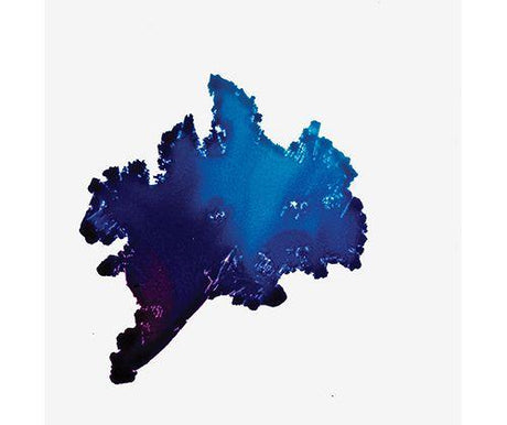 Vibrant blue and purple alcohol ink bleed demonstrating Jacquard Pinata Alcohol Ink's fluid characteristics, with deep indigo edges transitioning to bright turquoise at the centre, showing the ink's translucent layering and organic spreading pattern on white background.