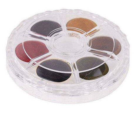 Round transparent disc containing six watercolour paint wells in earthy seasonal tones including deep burgundy, charcoal grey, warm beige, rich brown, black, and olive green. Koh-I-Noor Disc Watercolour Paint with clear segmented compartments in a compact circular palette format.