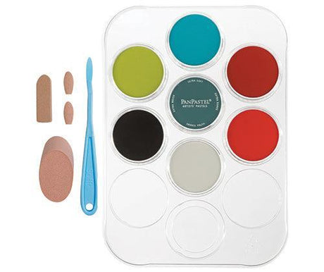 White plastic tray containing PanPastel Exploring Mixed Media Sets with nine circular pans in lime, teal, terracotta, black, grey, red and white colours. PanPastel branding visible on centre lid. Blue sculpting tool and three foam applicators in varying sizes arranged to the left of the tray.
